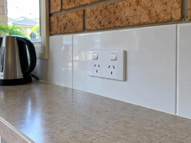 White double power point on tiled kitchen splashback above a benchtop in Pacific Pines